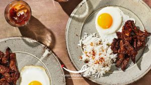 Tapsilog Filipino Rice Breakfast (Tapa, Sinangag at Itlog) Beef tapa with garlic fried rice and sunny-side-up egg