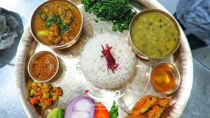 Serving and enjoying the meal of Nepali dal bhat