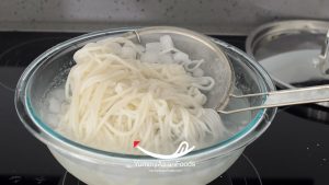 Step 5 in Cooking Singaporean Laksa Combine noodles and assemble dish